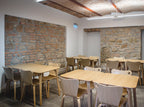 Modern dining area with wooden tables and chairs in a canteen.